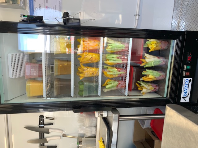 Fresh fruit cups in cooler at food truck